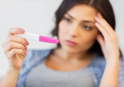 Woman holding pregnancy test